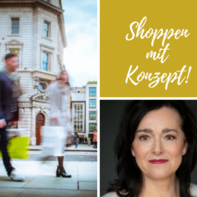 Menschen gehen auf einer Einkaufsstraße und haben Einkaufstaschen in der Hand.